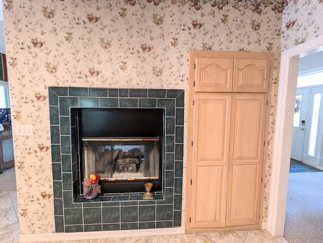 details featuring a tiled fireplace and carpet flooring