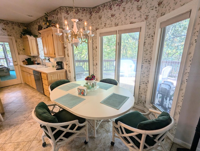 dining area featuring sink, light tile patterned floors, and plenty of natural light