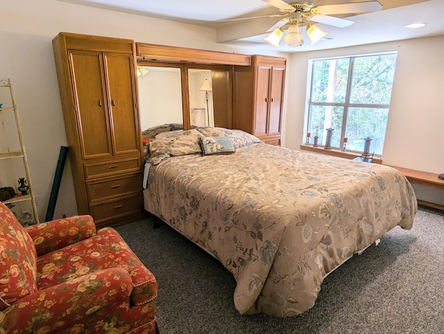 bedroom featuring ceiling fan and dark carpet