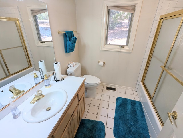 full bathroom with toilet, a healthy amount of sunlight, vanity, and tile patterned floors