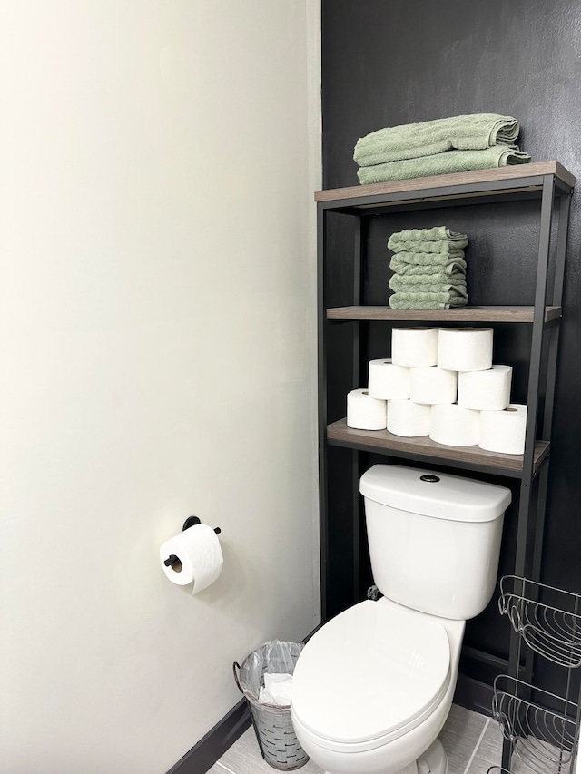 bathroom with toilet and tile patterned flooring