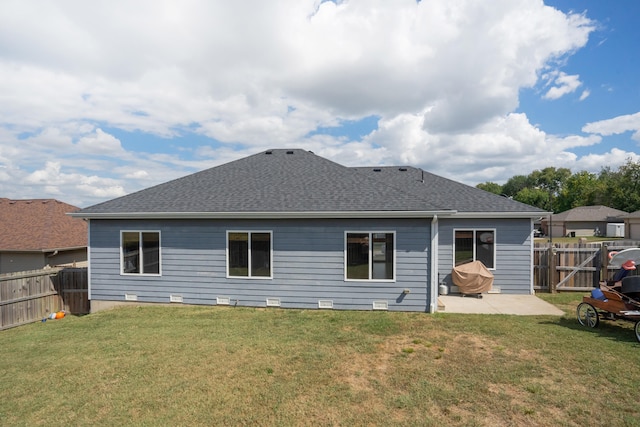 rear view of house with a yard and a patio area