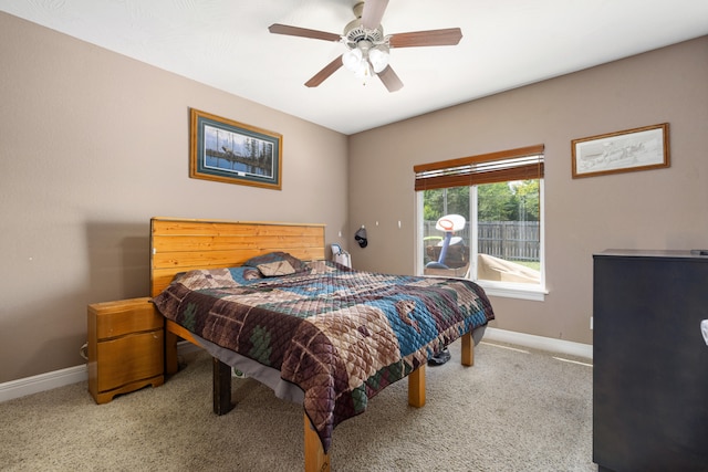 bedroom featuring light colored carpet and ceiling fan