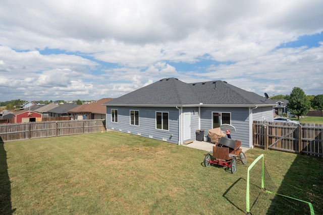 back of house featuring a yard and a patio area