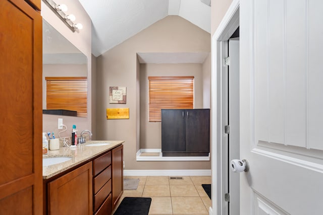 bathroom featuring vanity, lofted ceiling, and tile patterned flooring