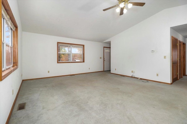 carpeted empty room featuring ceiling fan and lofted ceiling