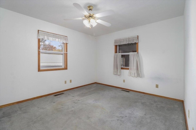 empty room featuring ceiling fan and carpet floors