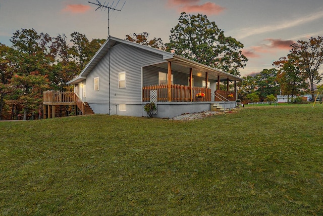 property exterior at dusk featuring a yard