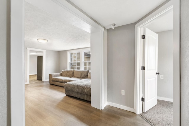 interior space featuring a textured ceiling and hardwood / wood-style floors