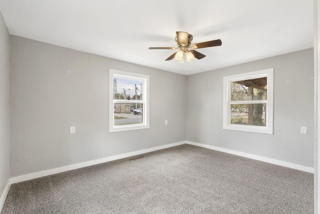 carpeted empty room featuring ceiling fan