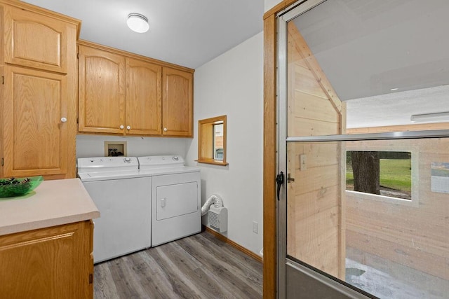 laundry area featuring cabinet space, independent washer and dryer, baseboards, and wood finished floors