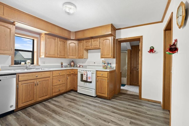 kitchen featuring a sink, dishwasher, light countertops, wood finished floors, and white electric stove