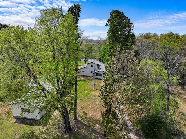 drone / aerial view featuring a view of trees