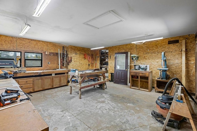 interior space featuring attic access and a workshop area