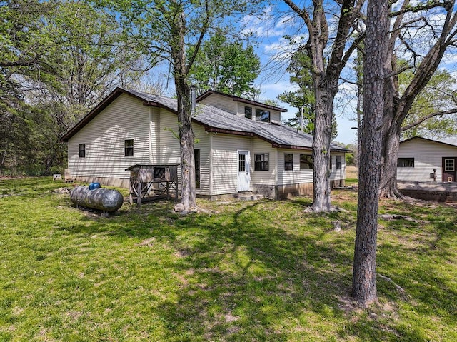 view of side of home featuring a yard and entry steps