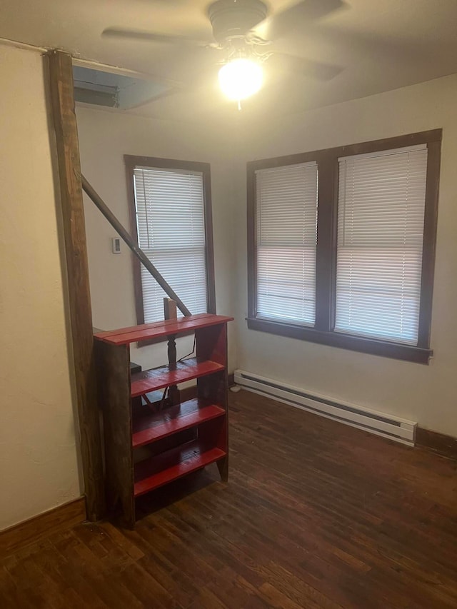 stairs with ceiling fan, hardwood / wood-style flooring, and baseboard heating