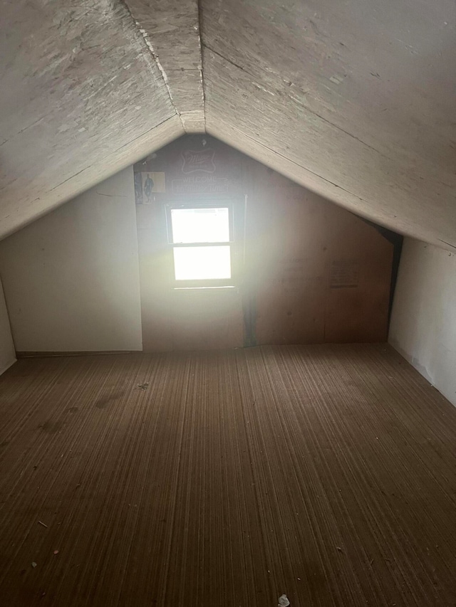 bonus room with lofted ceiling and dark hardwood / wood-style floors