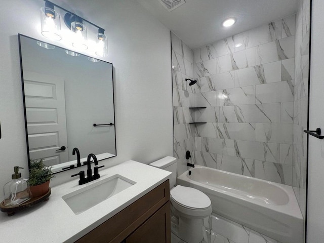 full bathroom featuring vanity, toilet, and tiled shower / bath