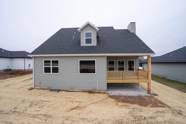 back of house with central air condition unit and a deck