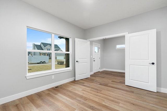 unfurnished room with light wood-type flooring