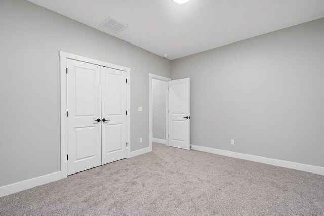 unfurnished bedroom with a closet and carpet