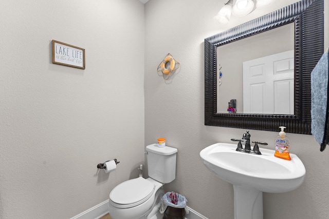 bathroom featuring sink and toilet