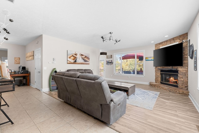 living room with light hardwood / wood-style flooring and a fireplace