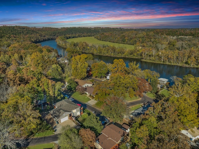 aerial view at dusk with a water view