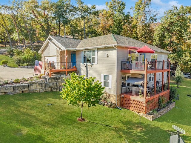 rear view of property with a yard and a deck