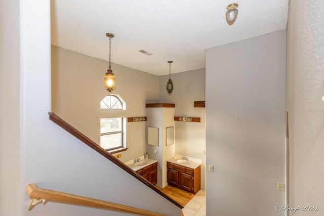 stairs with sink and tile patterned flooring