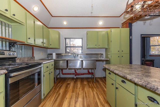 kitchen with electric stove, crown molding, green cabinetry, and light wood-type flooring