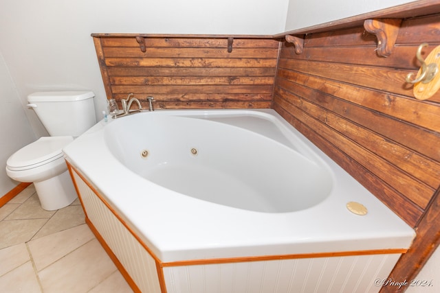 bathroom with toilet, a washtub, and tile patterned flooring