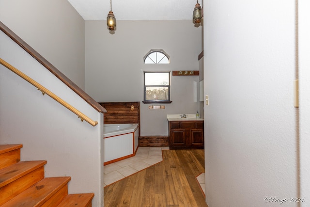 stairway featuring sink and wood-type flooring