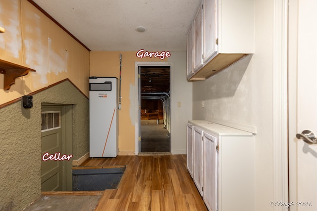 interior space featuring a textured ceiling and light wood-type flooring