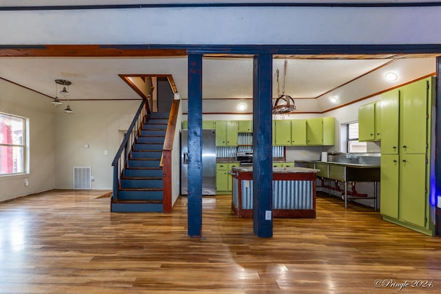 interior space featuring green cabinets, a wealth of natural light, and dark hardwood / wood-style floors