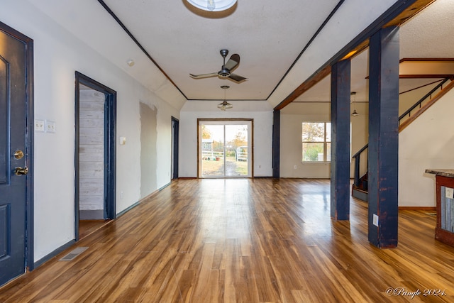 unfurnished living room featuring hardwood / wood-style floors, a textured ceiling, and ceiling fan