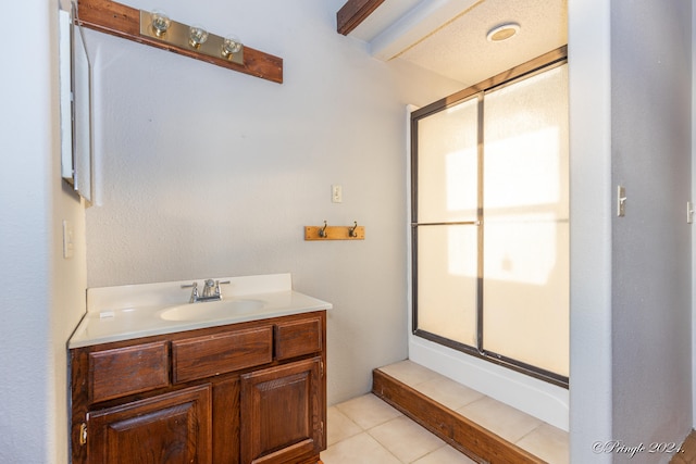 bathroom featuring vanity, tile patterned flooring, and an enclosed shower