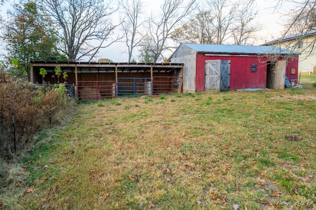 view of outdoor structure featuring a lawn