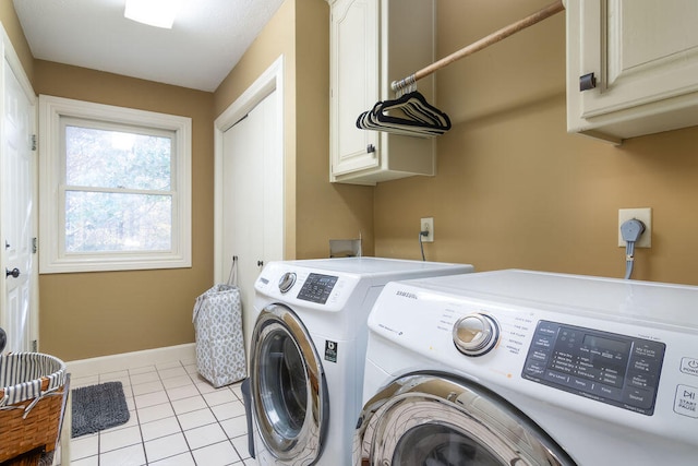 laundry room featuring cabinets, independent washer and dryer, and light tile patterned floors