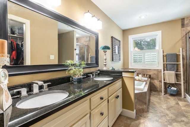 bathroom featuring vanity and separate shower and tub