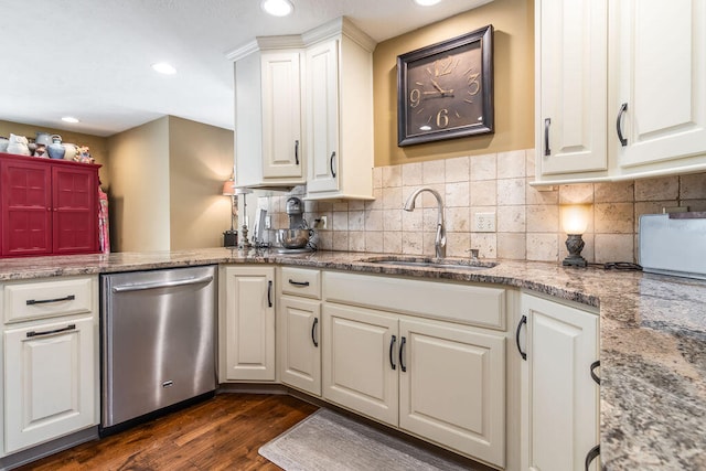 kitchen featuring white cabinets, light stone counters, dishwasher, dark hardwood / wood-style floors, and sink