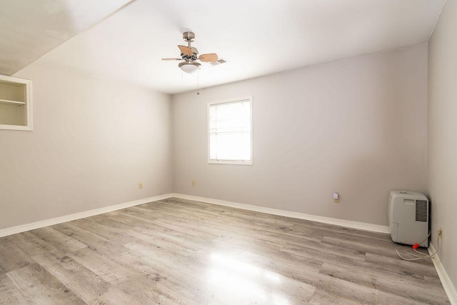 spare room featuring light hardwood / wood-style floors and ceiling fan