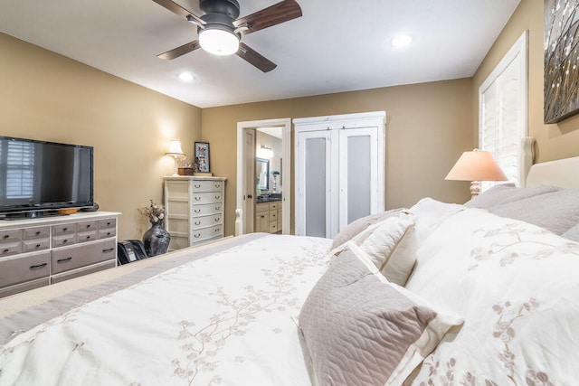 bedroom with ceiling fan and ensuite bath