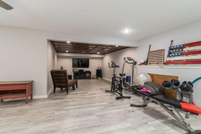 exercise room with light hardwood / wood-style floors