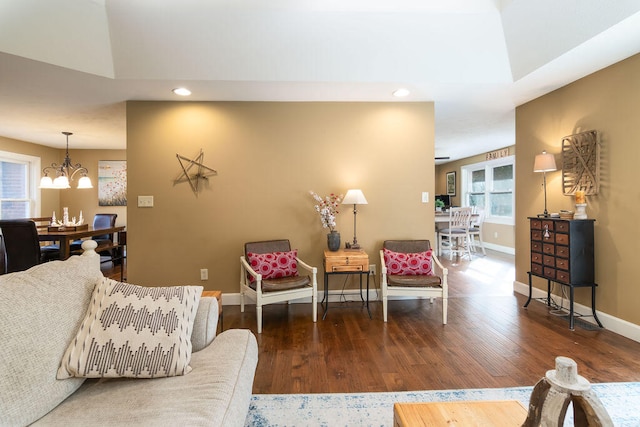 living room with a chandelier and hardwood / wood-style flooring