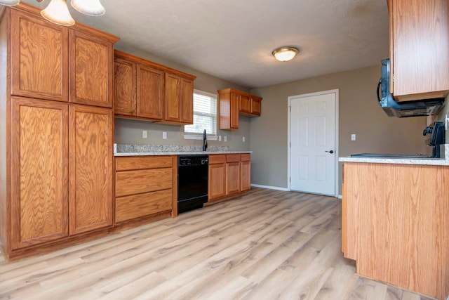 kitchen with sink, dishwasher, and light wood-type flooring