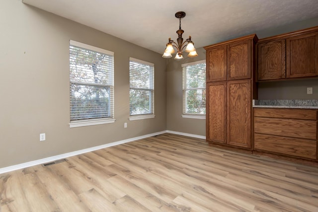 81 Clear Cove Dr, Reeds Spring, MO 65737 - unfurnished dining area with a chandelier, light wood finished floors, and baseboards