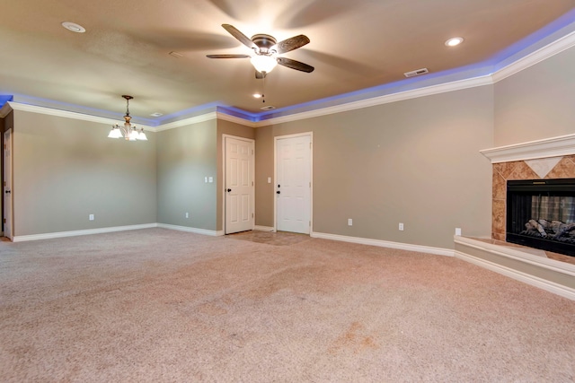 unfurnished living room featuring light carpet, ornamental molding, a fireplace, and ceiling fan