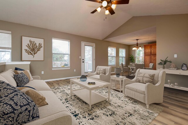 81 Clear Cove Dr, Reeds Spring, MO 65737 - living room featuring wood finished floors, a chandelier, ceiling fan, vaulted ceiling, and baseboards