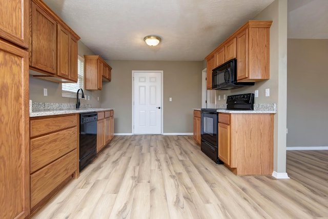 81 Clear Cove Dr, Reeds Spring, MO 65737 - kitchen featuring black appliances, light wood-style flooring, light countertops, and baseboards